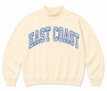 A product presentation showing a light yellow colored sweatshirt with EAST COAST letters arched on the center of the chest with blue and white stripes.