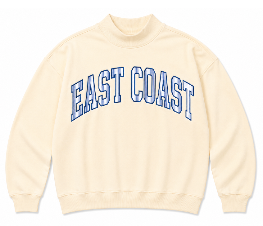 A product presentation showing a light yellow colored sweatshirt with EAST COAST letters arched on the center of the chest with blue and white stripes.