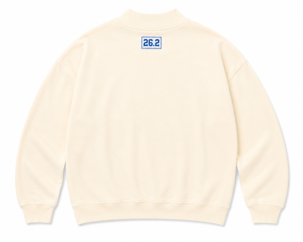 Light yellow sweatshirt with a blue 26.2 tag on the upper back.