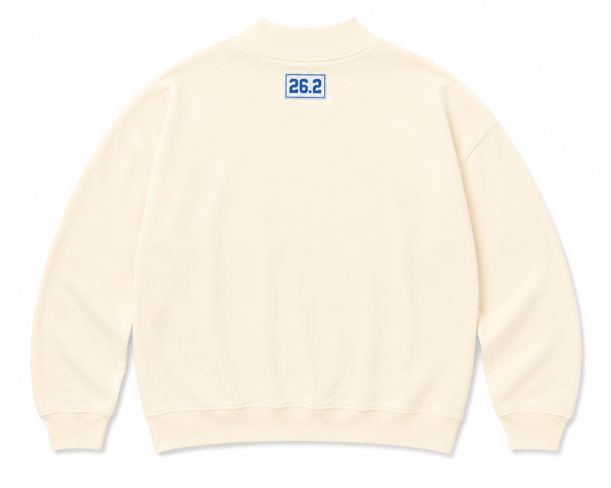 Light yellow sweatshirt with a blue 26.2 tag on the upper back.
