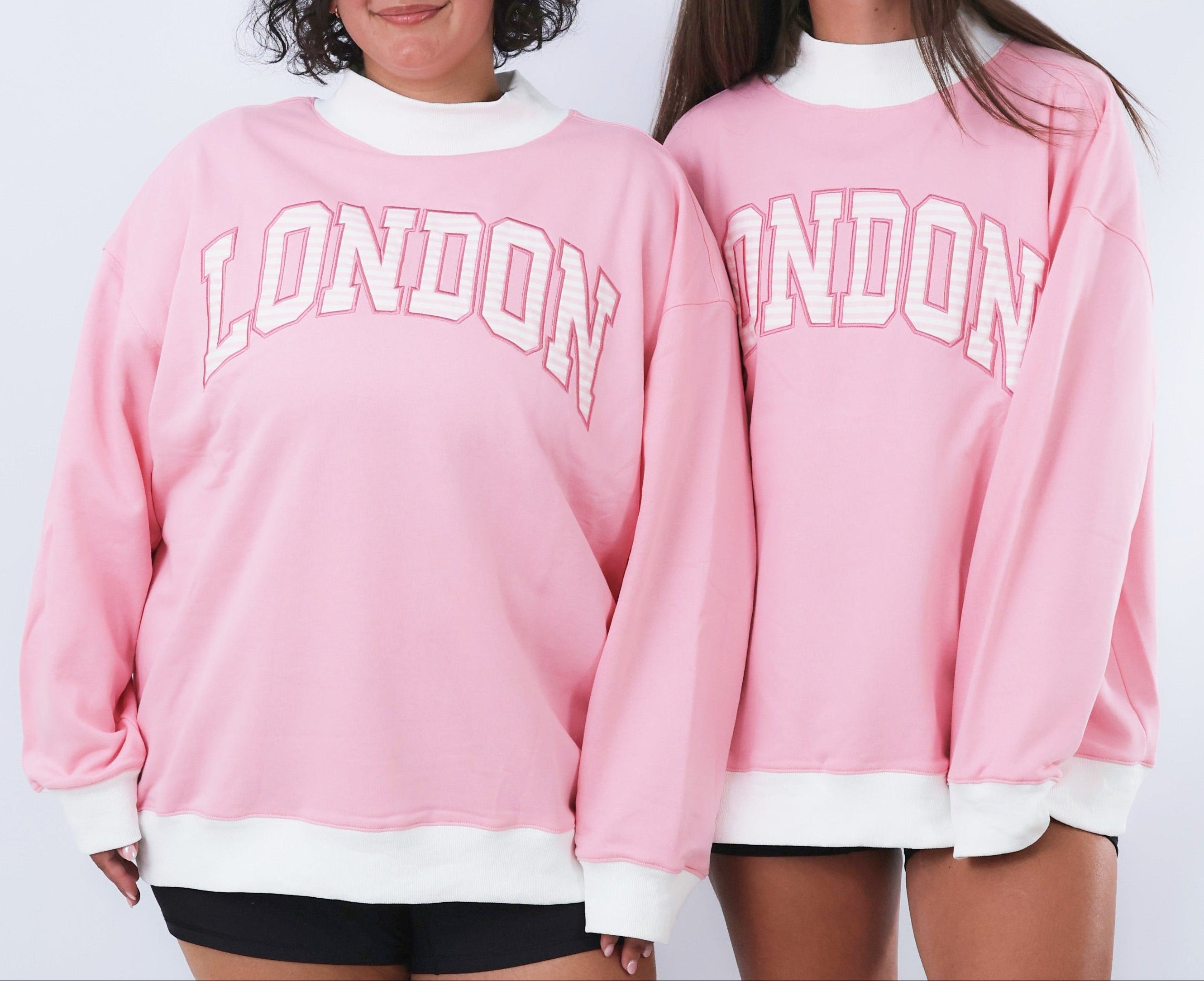 Two pink sweatshirts with 'LONDON' text on a white background